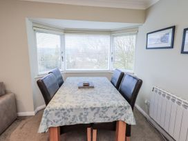 A dining room with a table and chairs at Lakeland Loft in Windermere