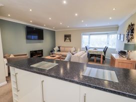 A living room with a sofa and a dining table at Lakeland Loft in Windermere