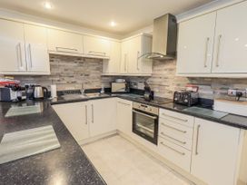 A kitchen with appliances and cabinets at Lakeland Loft in Windermere