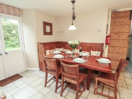 A dining room with a table set for dinner at Chapel How in Ambleside