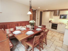 A kitchen with a dining table and chairs at Chapel How in Ambleside