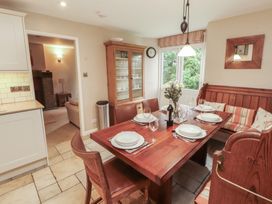 A dining room with a wooden table and chairs at Chapel How in Ambleside