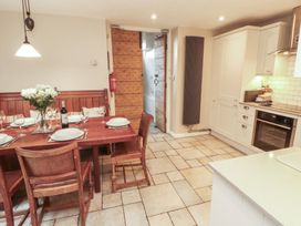 A kitchen with a dining table and chairs at Chapel How in Ambleside