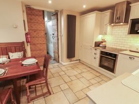 A kitchen with a dining table and chairs at Chapel How in Ambleside