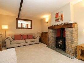 A living room with a sofa and fireplace at Chapel How, Ambleside