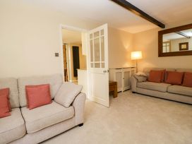 A living room with a sofa and lamp at Chapel How in Ambleside