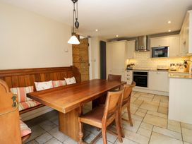 A kitchen with a dining table and bench at Chapel How in Ambleside