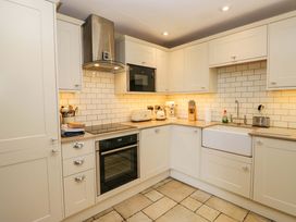 A kitchen with appliances and cabinetry at Chapel How in Ambleside