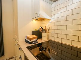 A kitchen with cabinets and utensils at Chapel How Ambleside