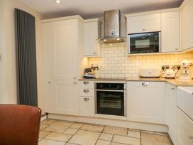A kitchen with cabinets and appliances at Chapel How in Ambleside