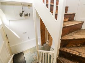 A hallway with stairs and a door at Chapel How in Ambleside