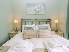 A bedroom with a bed and lamps at Chapel How, Ambleside