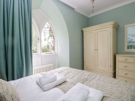 A bedroom with a bed and wardrobe at Chapel How in Ambleside