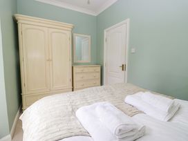 A bedroom with a bed and wardrobe at Chapel How in Ambleside