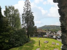 A view of a garden with trees and houses at Chapel How Ambleside