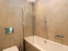 A bathroom with a bathtub and shower at Chapel How Ambleside