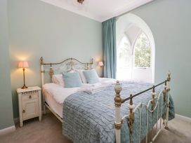 A bedroom with a bed and lamps at Chapel How in Ambleside