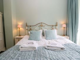 A bedroom with a bed and bedside tables at Chapel How in Ambleside