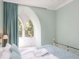 A bedroom with a bed and window at Chapel How in Ambleside