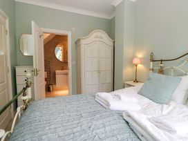 A bedroom with bed and wardrobe at Chapel How in Ambleside