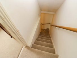 A staircase with carpet and handrail at Chapel How Ambleside