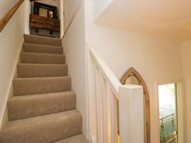 A staircase with a handrail leading upstairs at Chapel How in Ambleside