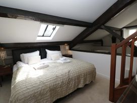 A bedroom with a bed and lamps at Chapel How in Ambleside