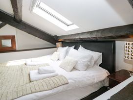 A bedroom with a bed and a lamp at Chapel How in Ambleside
