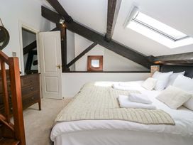 A bedroom with a bed and dresser at Chapel How in Ambleside