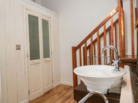 A bathroom with a sink and stairs at Chapel How Ambleside
