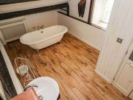 A bathroom with a bathtub and sink at Chapel How, Ambleside