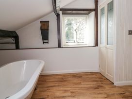 A bathroom with a bathtub and window at Chapel How Ambleside
