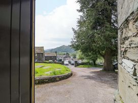 A view from a doorway showing trees and cars at Chapel How Ambleside