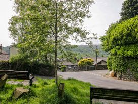 A street view with a tree and benches at Chapel How in Ambleside