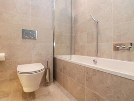 A bathroom with a toilet and bathtub at Chapel How in Ambleside