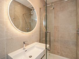 A bathroom with a sink and mirror at Chapel How in Ambleside