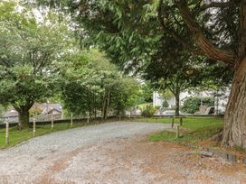 An outdoor area with a gravel driveway and trees at Chapel How in Ambleside