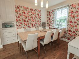 A dining room with a table and chairs at Newby Bridge House in Newby Bridge