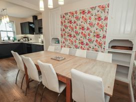 A dining room with a large table and chairs at Newby Bridge House in Newby Bridge