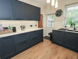 A kitchen with cabinets and appliances at Newby Bridge House in Newby Bridge