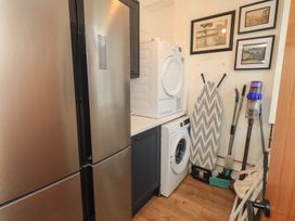 A laundry room with a refrigerator and appliances at Newby Bridge House in Newby Bridge