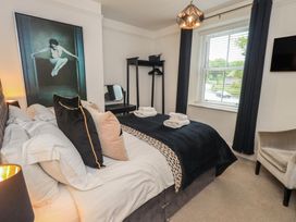 A bedroom with a bed and a wardrobe at Newby Bridge House in Newby Bridge