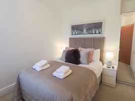 A bedroom with a bed and bedside table at Newby Bridge House in Newby Bridge