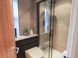 A bathroom with a shower and toilet at Newby Bridge House in Newby Bridge