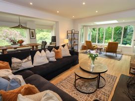 A living room with a sofa, coffee table, and chairs at Underheron in Grasmere
