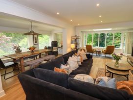 A living room with a sofa and dining area at Underheron in Grasmere