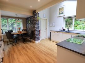 A kitchen with a dining area and kitchen appliances at Underheron in Grasmere