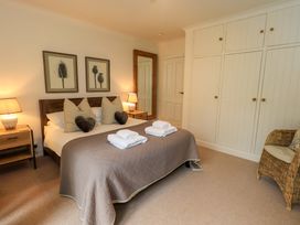 A bedroom with a bed and decorative wall art at Underheron in Grasmere