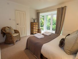 A bedroom with a bed and dresser at Underheron in Grasmere