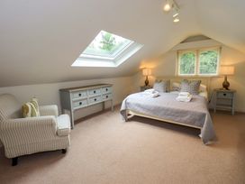 A bedroom with a bed and furniture at Underheron in Grasmere